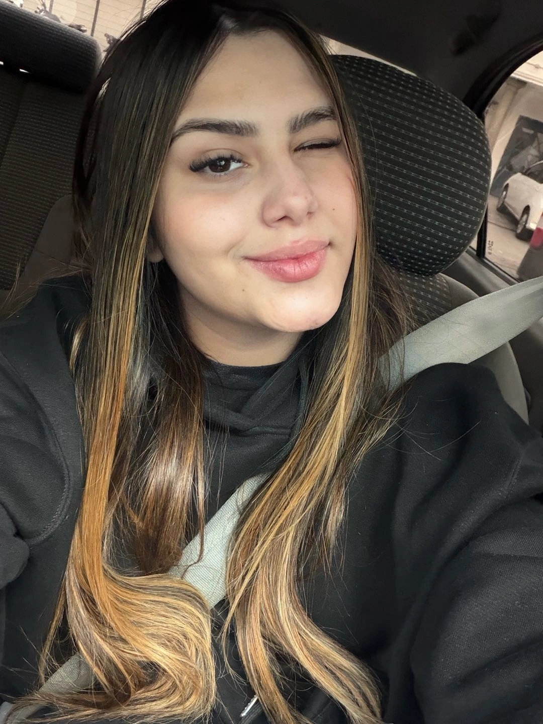 A smiling woman winking at the camera